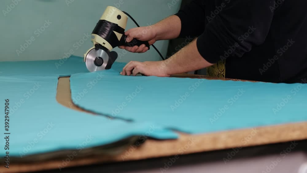 Woman Cuts Fabric on Cutting Table, Hands of Seamstress, Female Labor, Rotating Sharp Saw Blade, Folds Cloth in Half, Cut Piece of Material, Creative Work, Sewing Workshop, Female Hands, Round Blade Woman Cuts Fabric on Cutting Table, Hands of Seamstress, Female Labor, Rotating Sharp Saw Blade, Folds Cloth in Half, Cut Piece of Material, Creative Work, Sewing Workshop, Female Hands, Round Blade