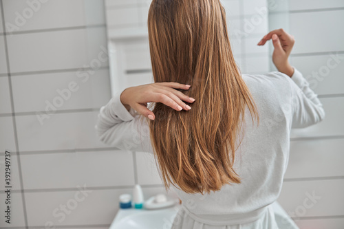 Young female with natural healthy fresh skin at home bathroom