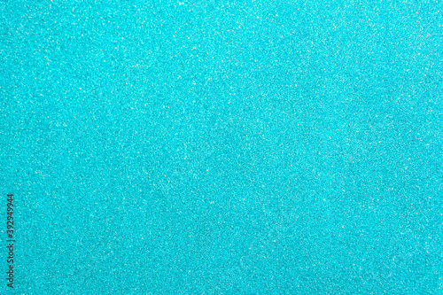 Abstract glitter blurred shiny blue aqua background. Bright sparkling bokeh wallpaper style. Festive Christmas holiday futuristic texture.