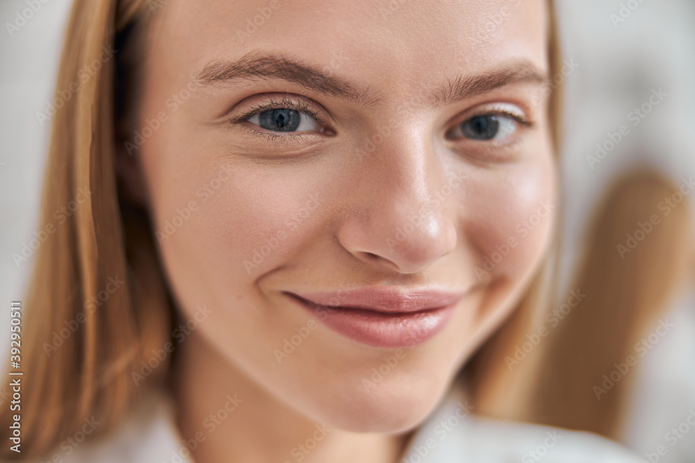 Young female with natural healthy fresh skin at home bathroom