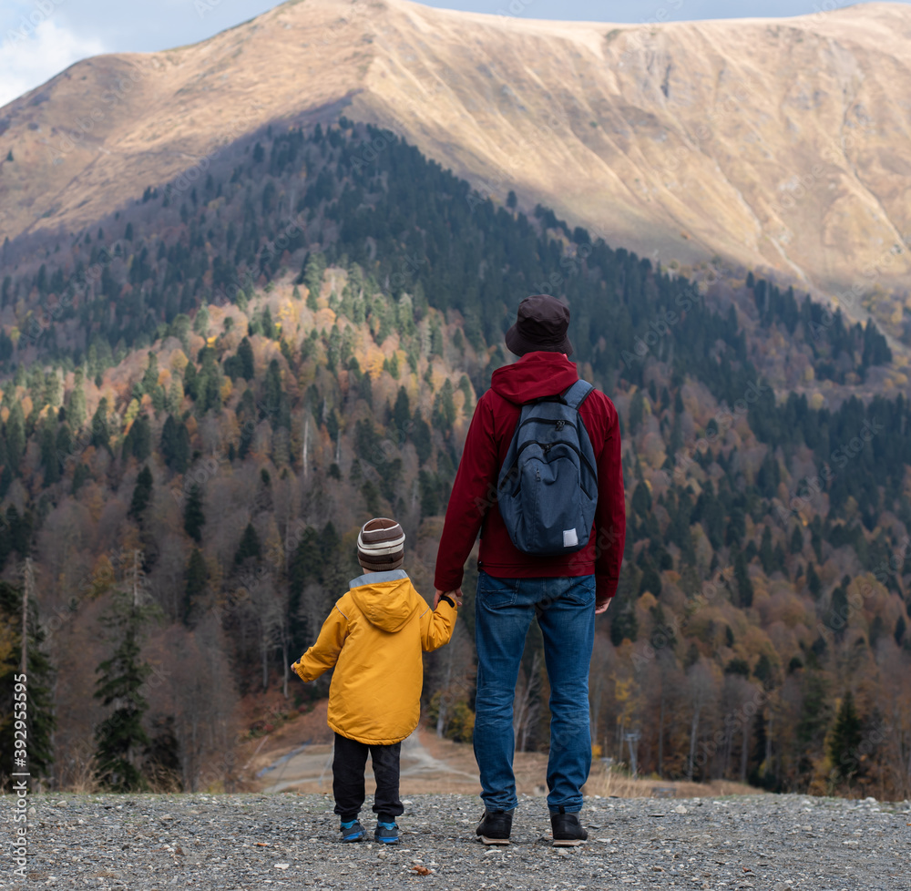 Young father and son walking in the mountains. Travel in the mountains. Beautiful scenery.