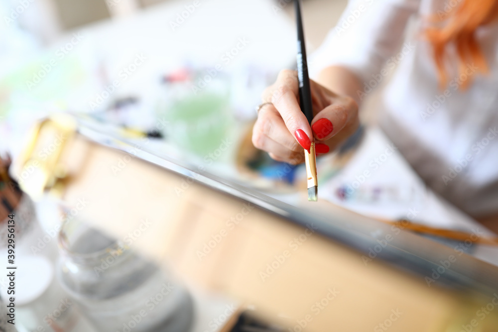 Fototapeta premium Female hand with red nails