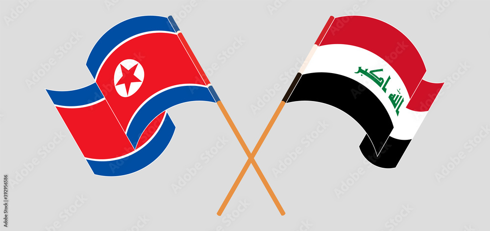 Crossed and waving flags of North Korea and Iraq
