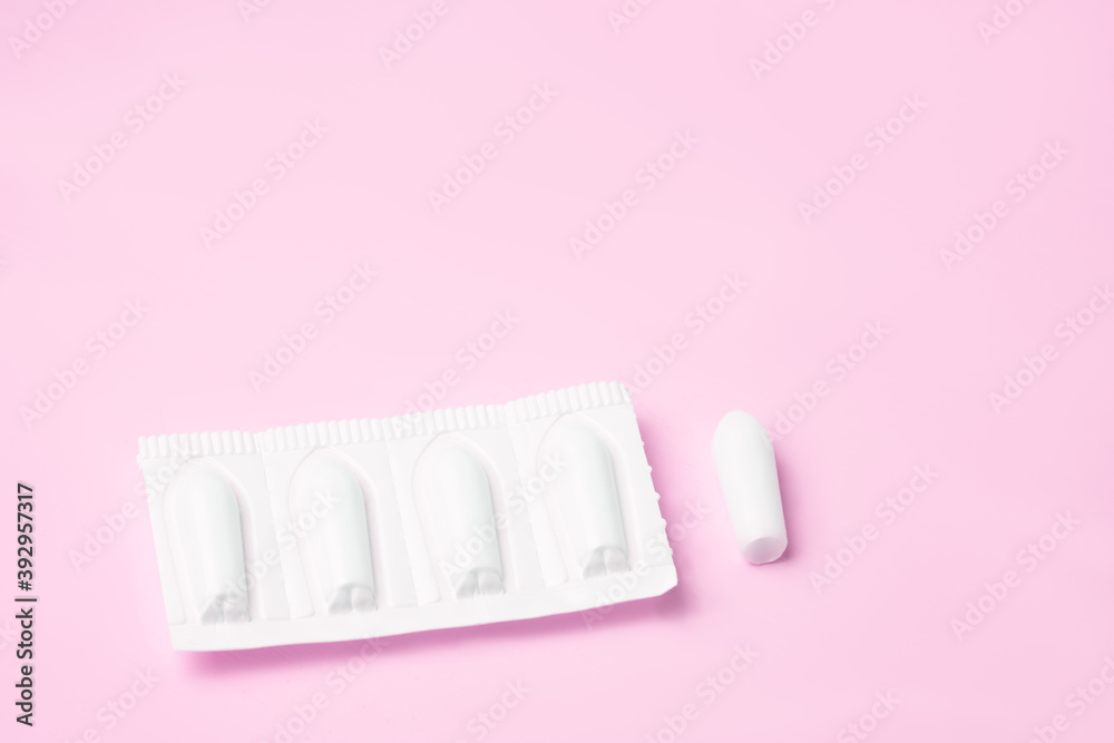 Background Candles for anal or vaginal use on a pink light background of the medication. Background Candles for anal or vaginal use on a pink light background of the medication.
