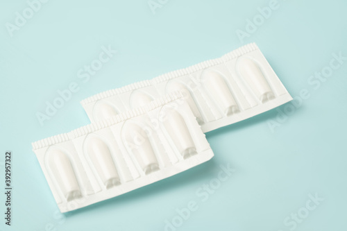 Background Candles for anal or vaginal use on a blue medication background.