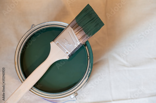 Fototapeta Naklejka Na Ścianę i Meble -  two inch paint brush on top a gallon of green paint