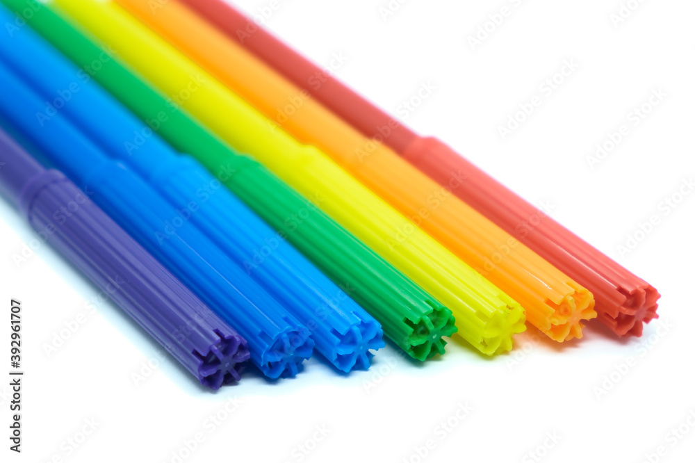 Colored felt-tip pens isolated on white background. Close-up colored markers on white. Drawing concept.