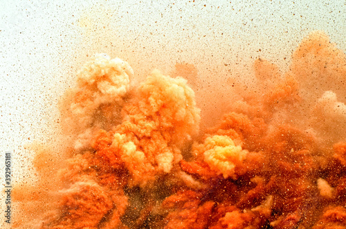 Flying rock particles and dust storm after detonator blast in the desert 