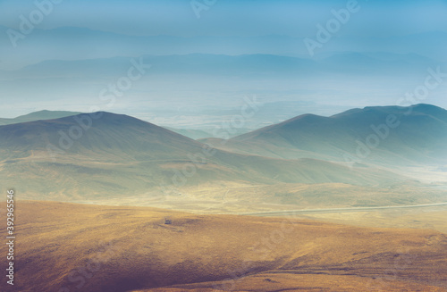 Amazing aerial view of desert, stone hills, and distant mountains layers range.Wilderness background. Vintage toning effect. Near Mount Erciyes. Kayseri, Turkey. 