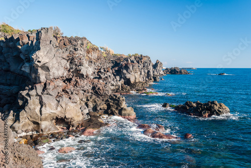 Rocky coastline of lava cliff near Acireale (Sicily, Italy)