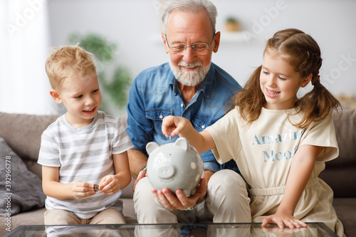Grandfather helping grandchildren to save money