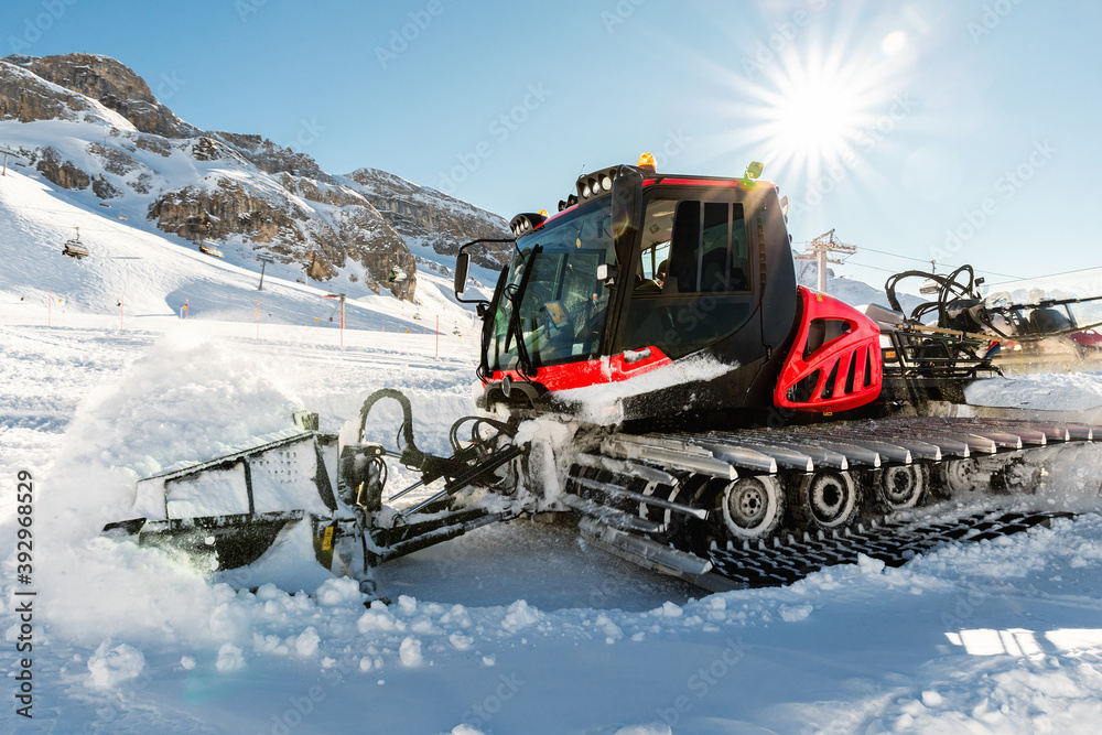 Red modern snowcat ratrack with snowplow snow grooming machine preparing ski slope piste hill at alpine skiing winter resort Ischgl in Austria. Heavy machinery mountain equipment track vehicle Red modern snowcat ratrack with snowplow snow grooming machine preparing ski slope piste hill at alpine skiing winter resort Ischgl in Austria. Heavy machinery mountain equipment track vehicle