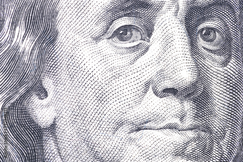 Macro close up of Ben Franklin's face on the US $100 dollar bill