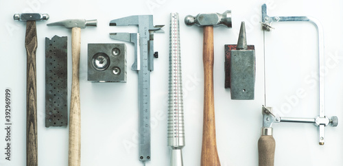 Jewelry tools. Jewellery. Goldsmith workplace, workspace on light background. Hand craft. Workshop. Manufacturing. Closeup. Toned metal top view background