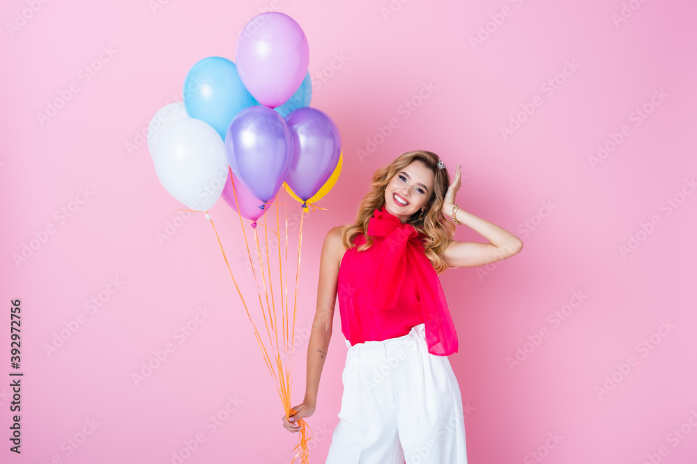 elegant happy woman in crown with balloons on pink background elegant happy woman in crown with balloons on pink background