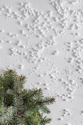 Evergreen trees branch with snow and snowballs in corner. Horizontal composition, flat lay, top view. Snow forest creative minimal layout with white background