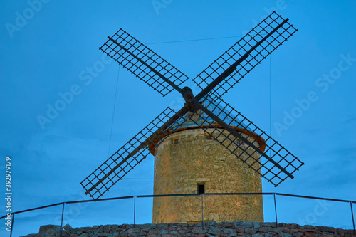 Image of a stone mill with cloudy sky in Las Ventas with Peña Aguilera, Toledo, Castilla La Mancha, Spain photo