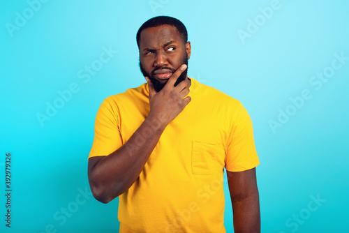 Confused man has some doubt about something. concept of options, confusion, indecision