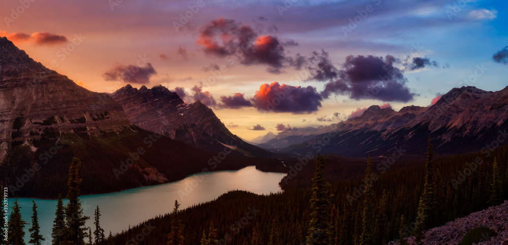 Canadian Rockies and Peyto Lake viewed from the top of a mountain. Dramatic Colorful Summer Sunset. Taken in Icefields Parkway, Banff National Park, Alberta, Canada.