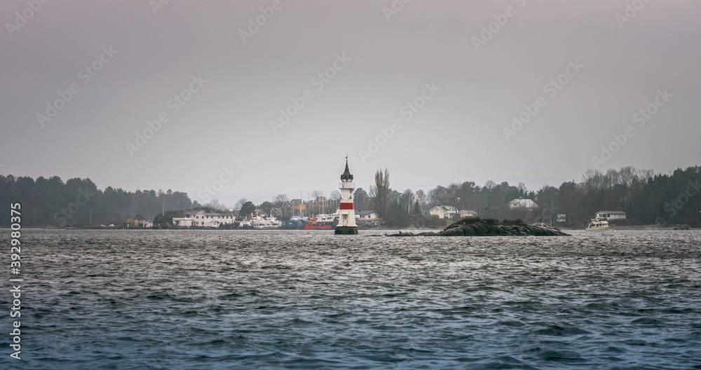 light house in Oslo Fjord on a stormy dark day.