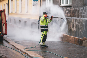 Acrylglasbilder Graffiti Man washing graffiti away.  © Stasys
