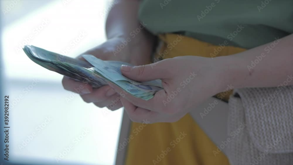 Close up of female hands counting a large amount of money by hand, a woman counts cash. Concept of wealth, money like an account, currency. Close up of female hands counting a large amount of money by hand, a woman counts cash. Concept of wealth, money like an account, currency.