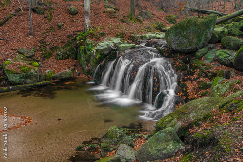 Maly Bily Stolpich waterfall in autumn fresh morning in Jizerske mountains photo