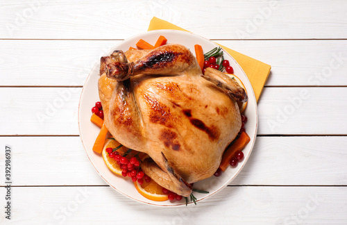 Delicious cooked turkey served on white wooden table, flat lay. Thanksgiving Day celebration