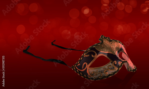 Beautiful carnival mask on red background, bokeh effect