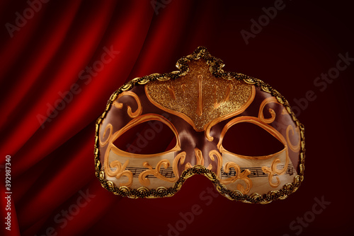 Beautiful carnival mask against red front curtain