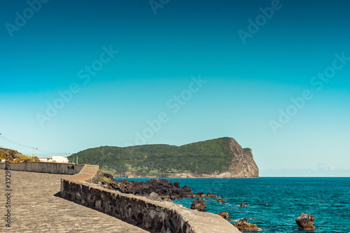 Seascape stone wall with Monte Brasil in the background, Terceira - Azores PORTUGAL