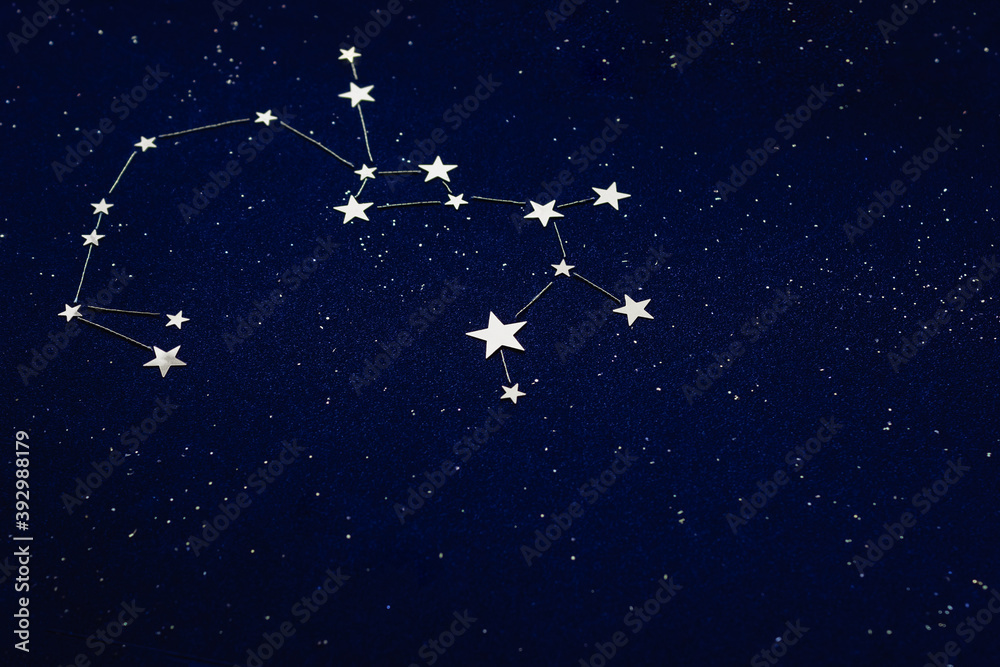 Zodiac sign Sagittarius on dark sky close up. The applique is made of silver star confetti and grainy blue cardboard. Horoscope Concept. Selective focus. Zodiac sign Sagittarius on dark sky close up. The applique is made of silver star confetti and grainy blue cardboard. Horoscope Concept. Selective focus.