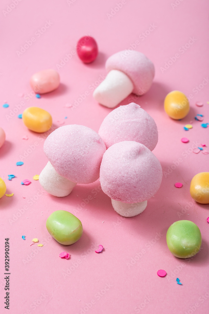 Pink and white marshmallow mushrooms on a pink background. Pink and white marshmallow mushrooms on a pink background.