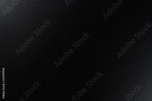 Background of a black wooden desk texture. Flat lay, top view, copy space