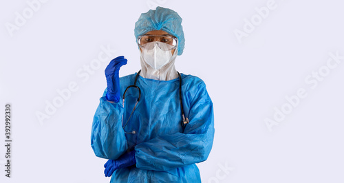 Asian female medical staff in PPE prepares for long hours operation helping patients get recovered in a quarantine room. Female doctor shows good sign of mental health and motivation in hospital room