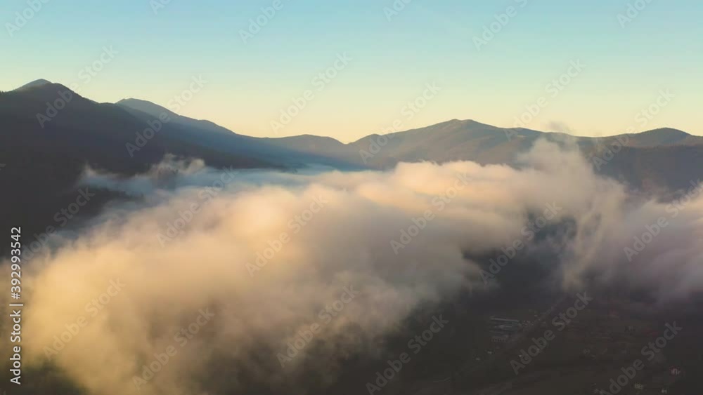 Fog in the intermountains of the mountain tops covered with autumn coniferous forest Fog in the intermountains of the mountain tops covered with autumn coniferous forest