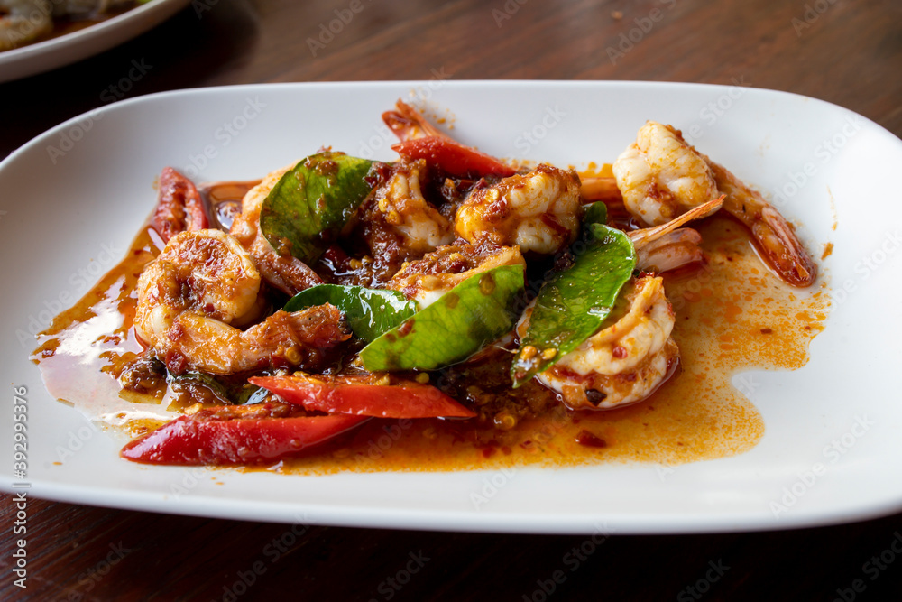 Thai stir fried shrimps with red chili paste, selective focus Thai stir fried shrimps with red chili paste, selective focus