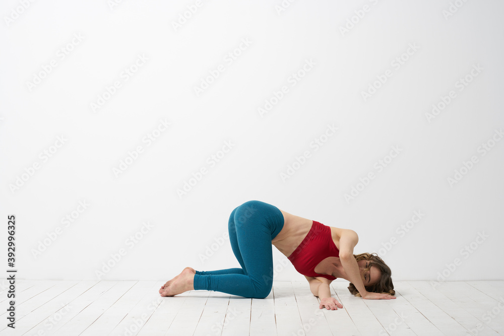 woman in leggings is engaged in gymnastics in a light room slim figure fitness sport woman in leggings is engaged in gymnastics in a light room slim figure fitness sport