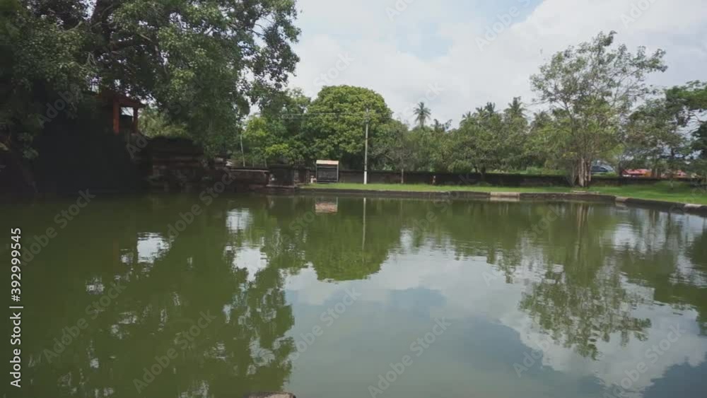 Beautiful temple pool with bodhi tree inside a sacred courtyard in India Beautiful temple pool with bodhi tree inside a sacred courtyard in India