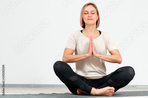 Woman performing hatha yoga meditation exercises