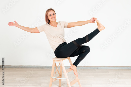 Athletic middle aged woman doing exercises..Hatha yoga
