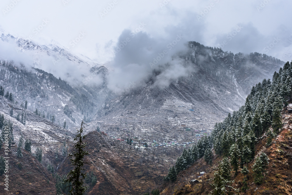 Beautiful winter landscape of Himalayas mountains with snow covered trees in Parvati Valley, Himachal Pradesh.
