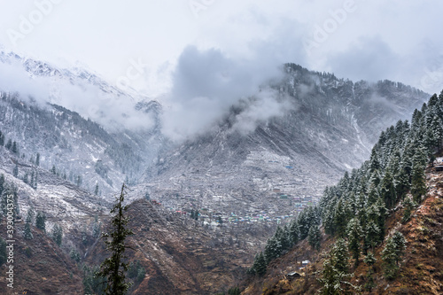 Beautiful winter landscape of Himalayas mountains with snow covered trees in Parvati Valley, Himachal Pradesh.