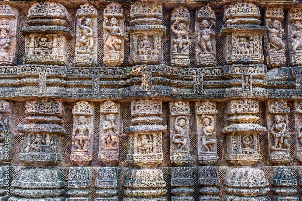 Ancient sandstone carvings on the walls of the ancient sun temple at Konark, India.
