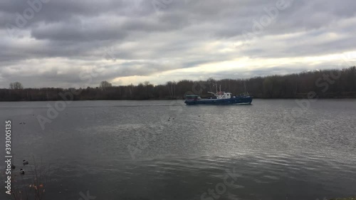 Small motor boat sailing on the river photo