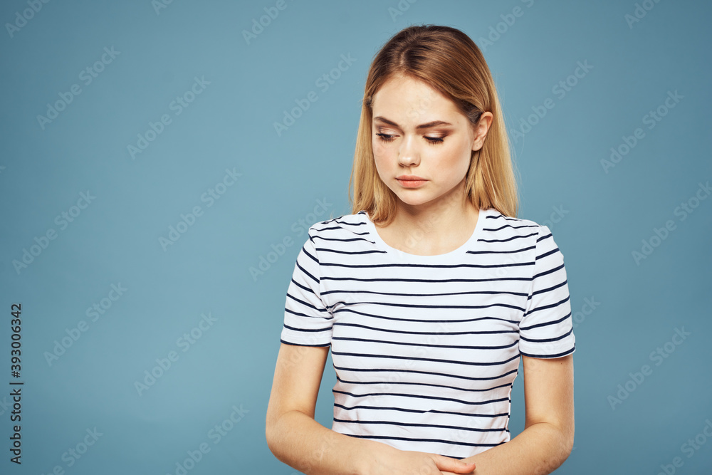 Emotional woman striped t-shirt lifestyle cropped blue background Emotional woman striped t-shirt lifestyle cropped blue background