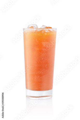 Orange juice with ice in a frozen glass on white background