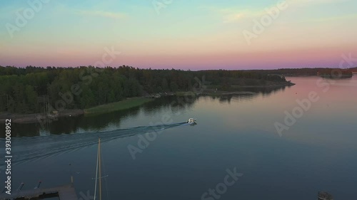 Speed boat Departs Marina Cruising to Archipelago Islands, Baggo, Sammarostrand, Finland, drone tracking shot photo