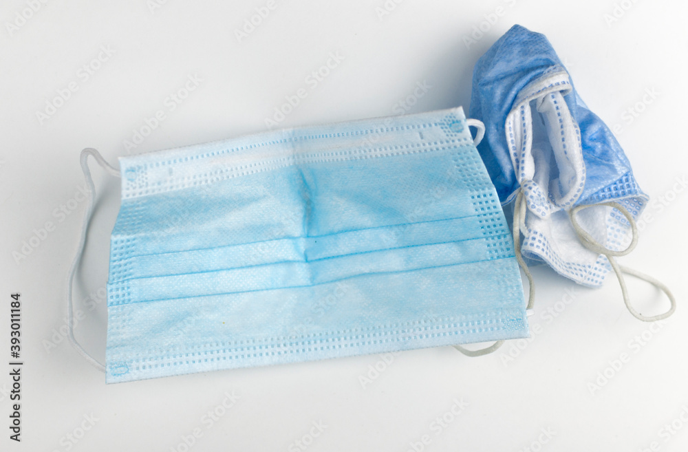 Crumpled used disposable medical face mask on white background