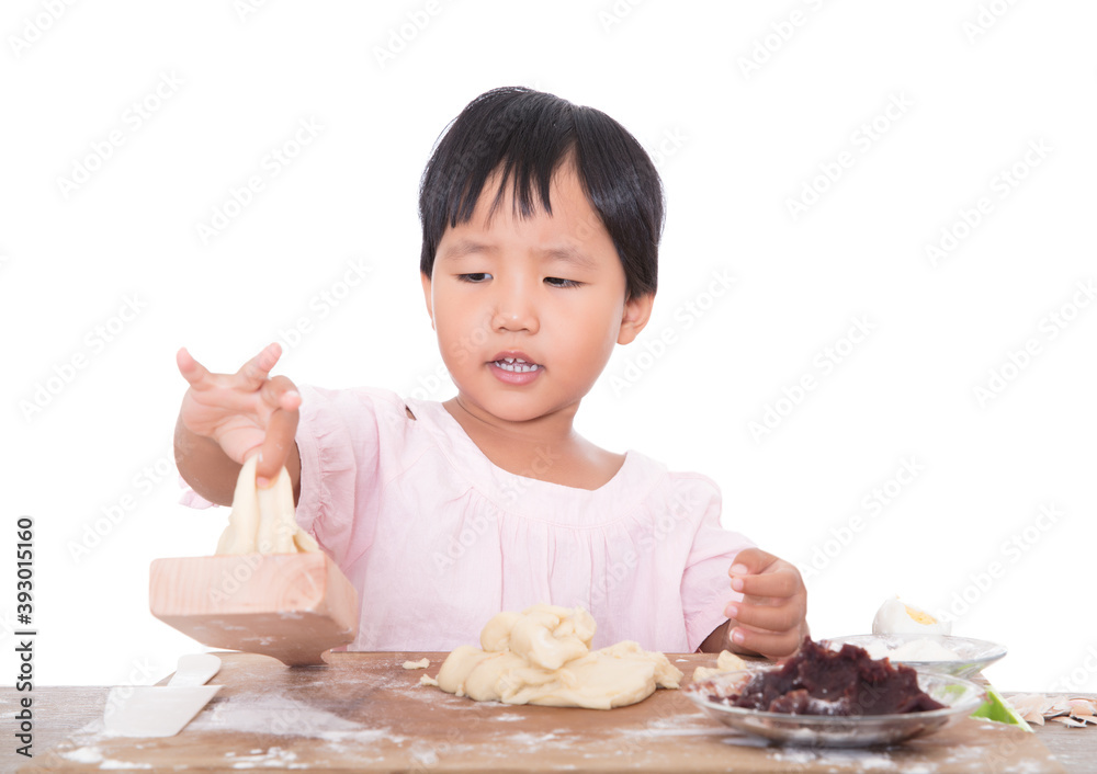 Little Asian girl learning to make moon cakes for Mid-Autumn Festival Little Asian girl learning to make moon cakes for Mid-Autumn Festival